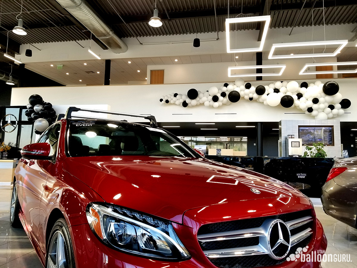 Large balloon display in a car dealership hosting an event.