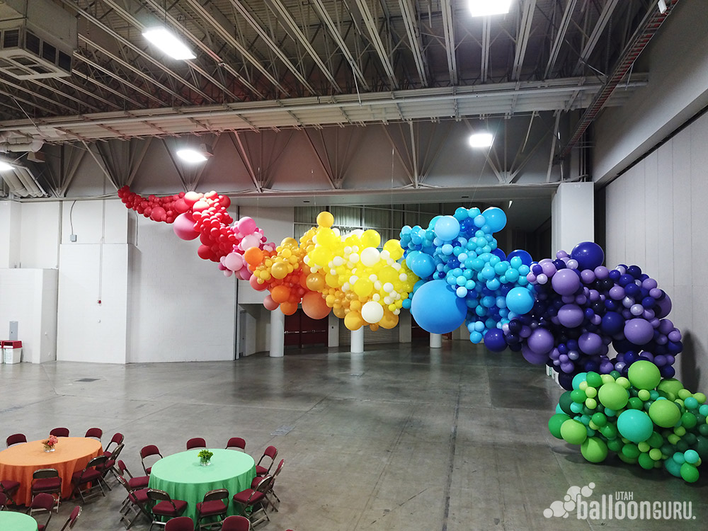 Large organic rainbow balloon sculpture.