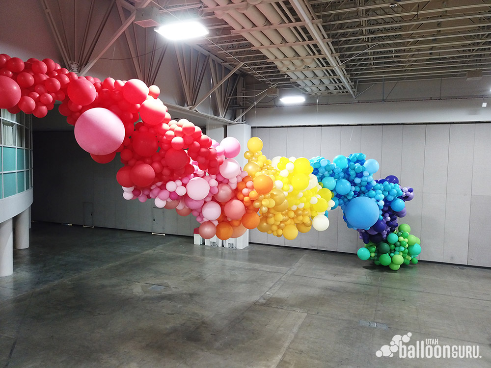 This large rainbow organic balloon sculpture was made by professional balloon decorators.