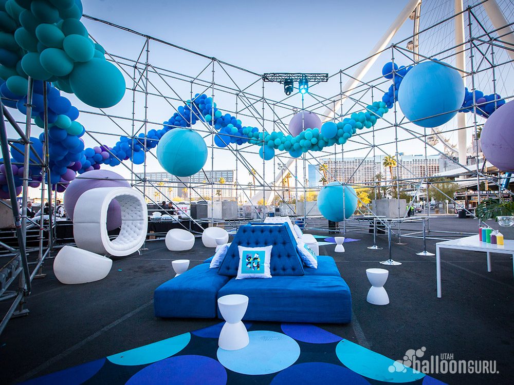 This is a lounge decorated with large balloons and organic balloon decor.