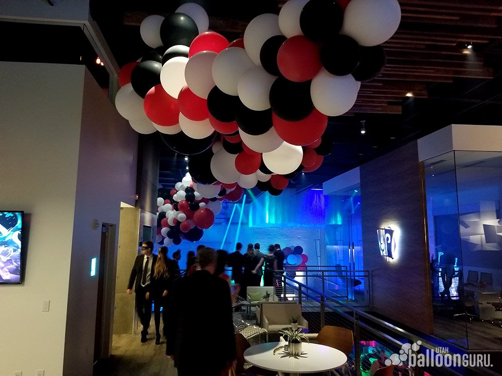 Balloons at a black tie masquerade party.